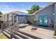 Inviting backyard deck with a hot tub, dining table, and comfortable seating area under a bright blue umbrella at 1209 W Adalee St, Tampa, FL 33603