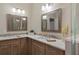 Enjoy getting ready in this bathroom with dual vanities, granite counters, and attractive wood cabinetry at 1209 W Adalee St, Tampa, FL 33603