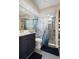 Modern bathroom featuring a stylish vanity, toilet, decorative shower curtain, and tiled walk-in shower at 1209 W Adalee St, Tampa, FL 33603