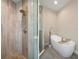 The walk-in shower has neutral tiling, while the tub is elegant and modern at 1209 W Adalee St, Tampa, FL 33603