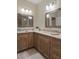 This bathroom has a dual sink vanity with granite countertops and attractive wood cabinets at 1209 W Adalee St, Tampa, FL 33603