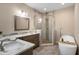 This bathroom has a modern soaking tub, glassed shower, and a granite-topped double vanity at 1209 W Adalee St, Tampa, FL 33603
