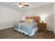 This bedroom has hardwood floors, a ceiling fan, and a neatly decorated bed with accent pillows at 1209 W Adalee St, Tampa, FL 33603