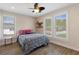 Cozy bedroom featuring a comfortable bed, natural light from the windows, and elegant wood-look flooring creating a warm atmosphere at 1209 W Adalee St, Tampa, FL 33603