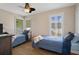 Sunlit bedroom with twin beds and wood-look flooring, providing a cozy and inviting space at 1209 W Adalee St, Tampa, FL 33603