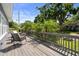 Inviting outdoor deck area with charming furniture and lush tropical landscaping at 1209 W Adalee St, Tampa, FL 33603