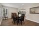 Light-filled dining room featuring hardwood floors, neutral walls, and an elegant four-chair dining set at 1209 W Adalee St, Tampa, FL 33603