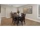Warm dining room with hardwood floors, neutral tones, and an elegant four-chair dining set at 1209 W Adalee St, Tampa, FL 33603