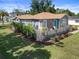 Aerial view of a well-kept home, showcasing the expansive yard, attractive landscaping, and charming deck at 1209 W Adalee St, Tampa, FL 33603