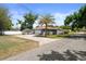 Well-maintained home with a spacious driveway, detached garage, and a beautiful palm tree at 1209 W Adalee St, Tampa, FL 33603