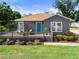 Beautifully landscaped front yard with a charming home and inviting deck at 1209 W Adalee St, Tampa, FL 33603