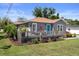 Inviting home with a welcoming front deck and lush landscaping, enhancing its curb appeal at 1209 W Adalee St, Tampa, FL 33603