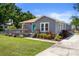 Attractive home with a front deck and well-maintained landscaping creating a warm and inviting exterior at 1209 W Adalee St, Tampa, FL 33603
