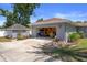 View of the detached garage featuring an open garage, landscaping, exterior lighting, and yard at 1209 W Adalee St, Tampa, FL 33603