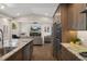 Modern kitchen with stainless appliances and granite countertops opens to living room at 1209 W Adalee St, Tampa, FL 33603