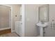 Laundry room with utility sink, white cabinetry and a tile floor at 1209 W Adalee St, Tampa, FL 33603