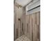 Walk-in shower showcasing elegant wall tiles, convenient fixtures, and mosaic floor tiles at 1209 W Adalee St, Tampa, FL 33603