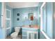 Charming blue bathroom features built-in storage, updated vanity, and tiled floors at 12501 Ulmerton Rd # 89, Largo, FL 33774