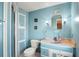 Well-lit bathroom features a storage cabinet, a newer vanity, and a corner shower at 12501 Ulmerton Rd # 89, Largo, FL 33774