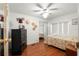 Cozy bedroom with wood floors, a ceiling fan, and a mirrored closet at 12501 Ulmerton Rd # 89, Largo, FL 33774