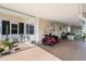 Covered carport offering convenient parking and outdoor seating with an entrance to the home's screen room at 12501 Ulmerton Rd # 89, Largo, FL 33774