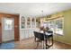 Cozy dining area with a glass table, built-in storage, and wood laminate floors for a welcoming atmosphere at 12501 Ulmerton Rd # 89, Largo, FL 33774