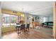 Open-concept living and dining area with natural light, wood laminate flooring, and comfortable seating at 12501 Ulmerton Rd # 89, Largo, FL 33774