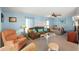 Inviting living room features neutral carpet, a decorative ceiling fan, and bright, airy natural light at 12501 Ulmerton Rd # 89, Largo, FL 33774