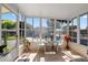Bright and airy screen room with tile floors, a dining set, and expansive windows offering natural light at 12501 Ulmerton Rd # 89, Largo, FL 33774