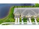 An aerial view of well-maintained townhomes with garages overlooking a serene pond at 12952 Utopia Gardens Way, Riverview, FL 33579
