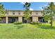 Rear exterior features screened patios overlooking the expansive lawn at 12952 Utopia Gardens Way, Riverview, FL 33579