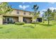 The backyard has a well-manicured lawn, screened patios, and view of the lake at 12952 Utopia Gardens Way, Riverview, FL 33579