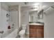 Bright bathroom features a shower-tub combo, decorative wall art, and granite countertop vanity at 12952 Utopia Gardens Way, Riverview, FL 33579