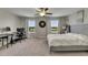 Bedroom with large windows, desk, comfy chair, and closet for plenty of storage at 12952 Utopia Gardens Way, Riverview, FL 33579