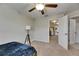 Bedroom featuring a ceiling fan and gray carpet with an open door that provides hallway access at 12952 Utopia Gardens Way, Riverview, FL 33579