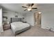 Bedroom with large bed, nightstands and a view into the bathroom and hallway at 12952 Utopia Gardens Way, Riverview, FL 33579