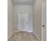 A tiled entryway with a white front door and white trim with access to a coat closet at 12952 Utopia Gardens Way, Riverview, FL 33579