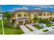Inviting exteriors with two-car garages, brown shutters, mature landscaping, and ample parking at 12952 Utopia Gardens Way, Riverview, FL 33579