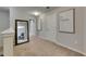 Upstairs hallway featuring neutral carpeting, white trim, and framed mirrors at 12952 Utopia Gardens Way, Riverview, FL 33579