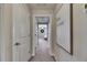 Hallway with carpet and a framed art piece with a view of the bedroom at the end of the hall at 12952 Utopia Gardens Way, Riverview, FL 33579