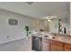 Open concept kitchen with granite countertops, stainless dishwasher, and view of open-concept living area at 12952 Utopia Gardens Way, Riverview, FL 33579