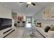Open concept living room with tile flooring, ceiling fan, and neutral paint color at 12952 Utopia Gardens Way, Riverview, FL 33579