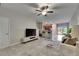 Bright living space featuring tile flooring, modern ceiling fan, and view of the kitchen at 12952 Utopia Gardens Way, Riverview, FL 33579