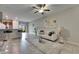 Bright living room featuring modern decor, neutral colors, ceiling fan, and sliding glass doors at 12952 Utopia Gardens Way, Riverview, FL 33579