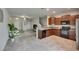 A spacious open concept living area featuring tile floor, and an island with seating at 12952 Utopia Gardens Way, Riverview, FL 33579
