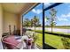 Screened patio offering serene views of the lake at 12952 Utopia Gardens Way, Riverview, FL 33579
