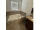 Relaxing bathroom with a large soaking tub and a vanity at 13172 Green Violet Dr, Riverview, FL 33579