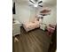 Charming bedroom with wood flooring, a ceiling fan, and a cozy decor at 13172 Green Violet Dr, Riverview, FL 33579