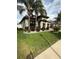 Well-manicured lawn and landscaping surround this home with a tile roof and attached garage at 13172 Green Violet Dr, Riverview, FL 33579