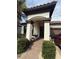 Inviting front entrance featuring an archway, columns, and a cozy seating area at 13172 Green Violet Dr, Riverview, FL 33579